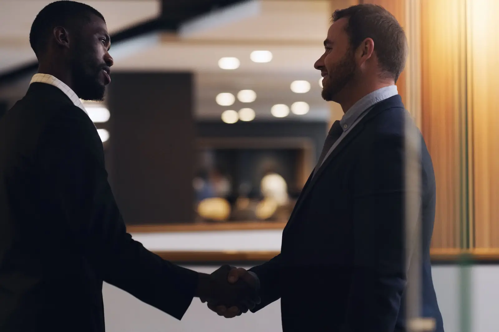 A business owner and a consultant shaking hands